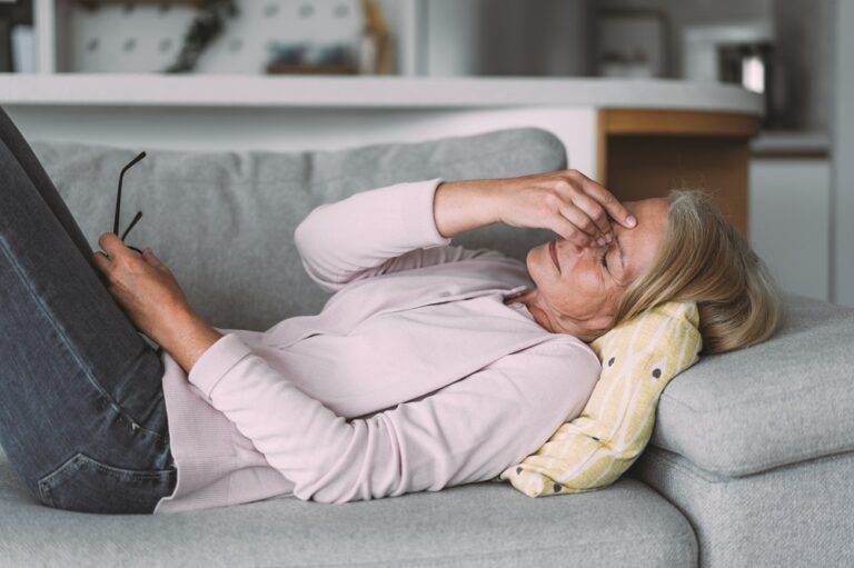 Woman suffering with a migraine.