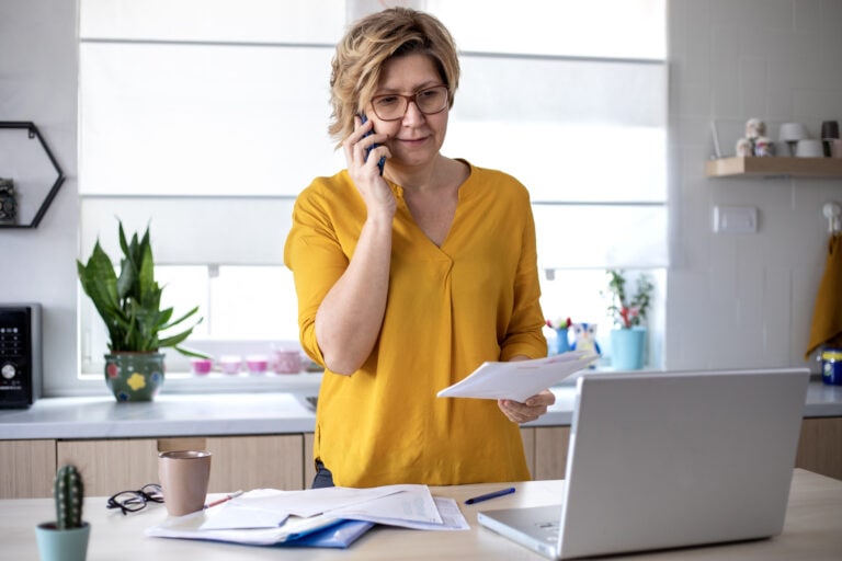 Concentrated mature woman calculating finance