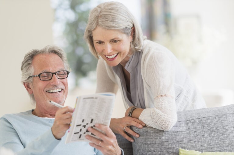 USA, New Jersey, Jersey City, Senior couple doing crossword
