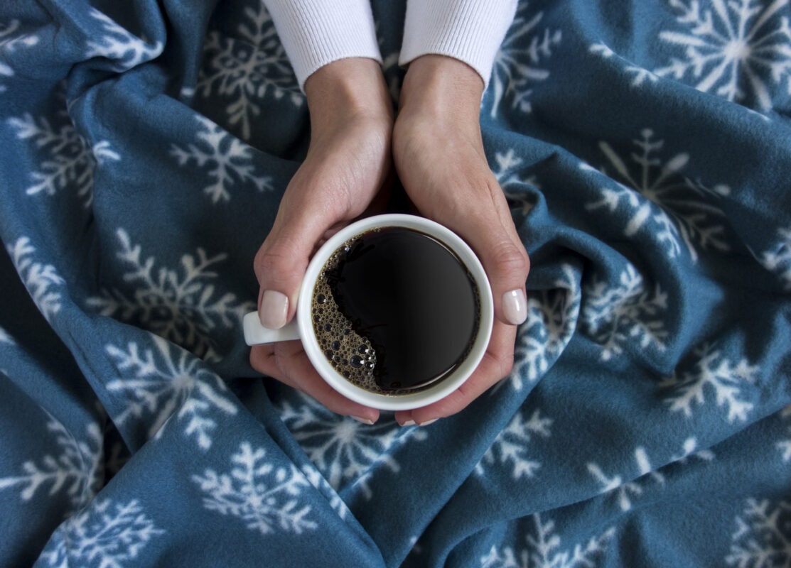 holding a cup of coffee