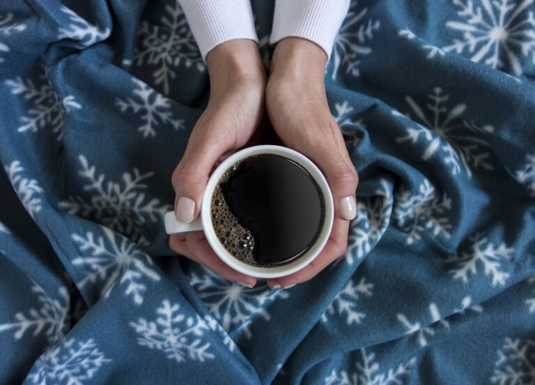 holding a cup of coffee