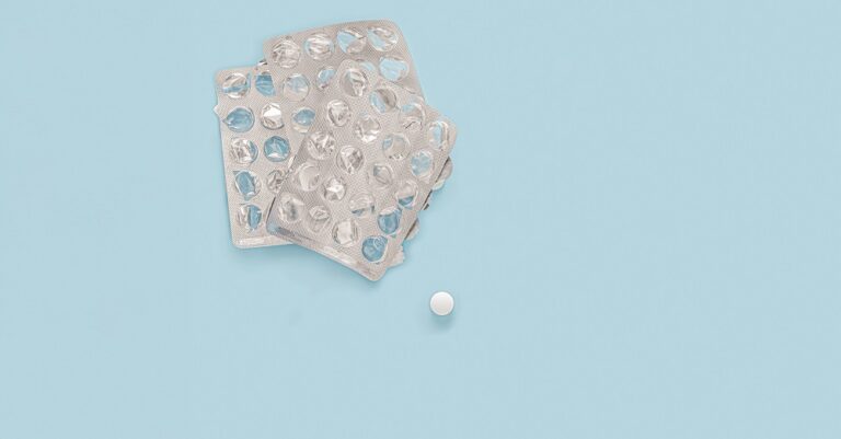 last pill. empty pill packaging. drug shortage deficiency concept. Empty packs of pills and last pill isolated on blue background. top view
