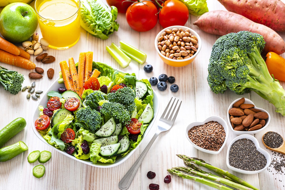 Vegan food: healthy salad plate on white table.