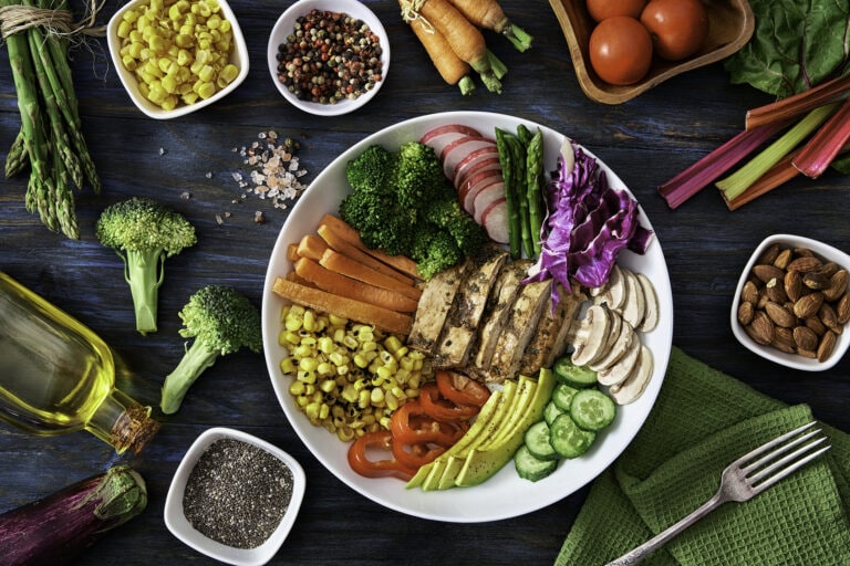 Healthy eating and diet concepts. Top view of spring salad shot from above on rustic wood table.