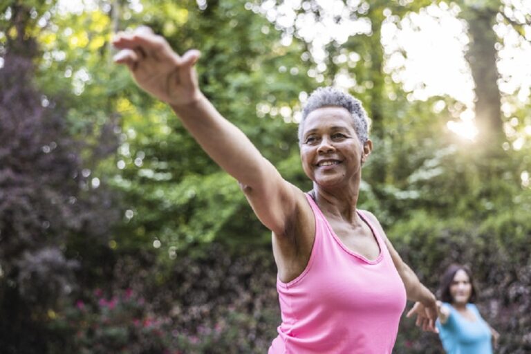 Senior women taking a yoga in beautiful garden