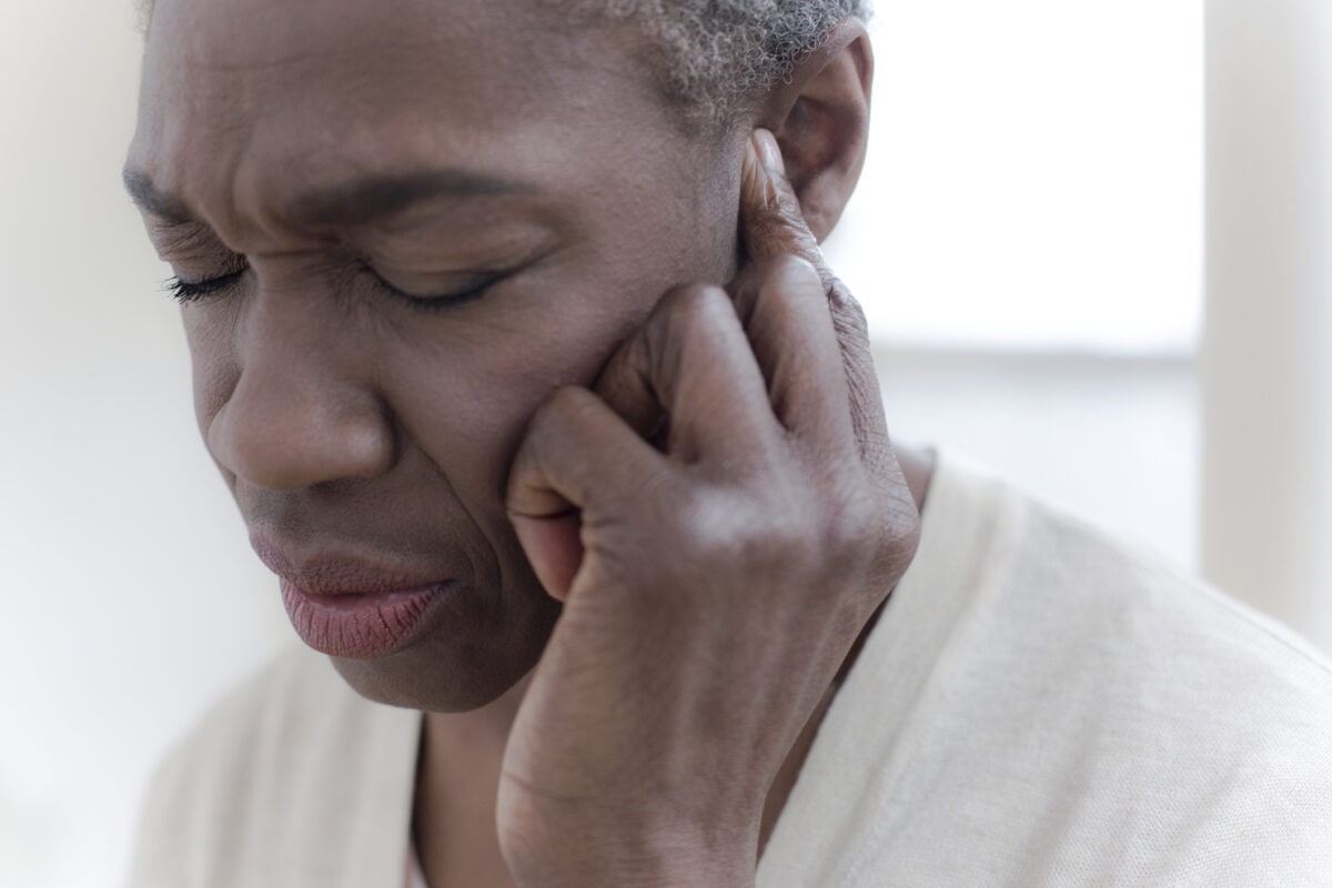 Woman touching ear