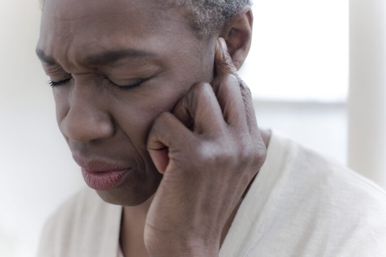 Woman touching ear