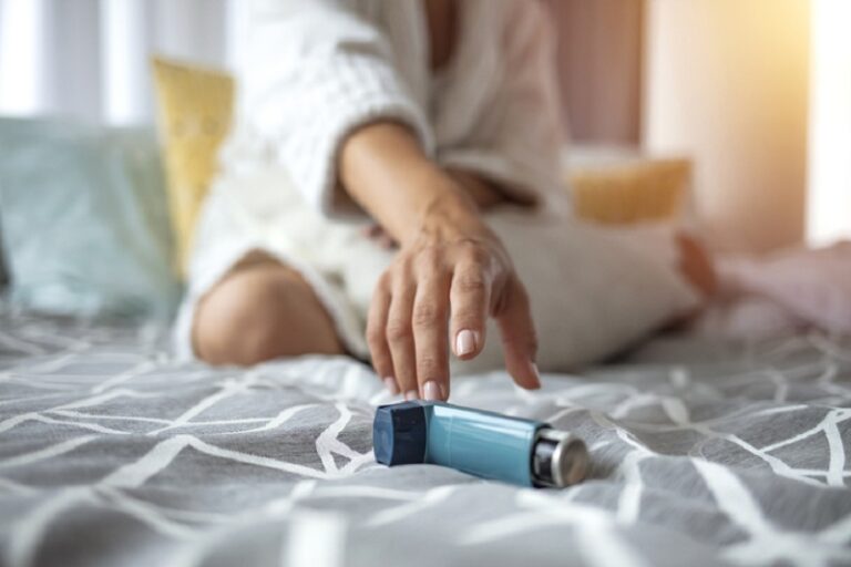 Asmathic girl catching inhaler having an asthma attack