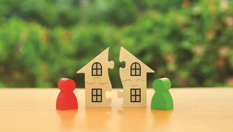 Two human figures divide the house among themselves. Divorce concept. Disputes over division process of real estate and property between former spouses, relatives. Execution of the posthumous will.
