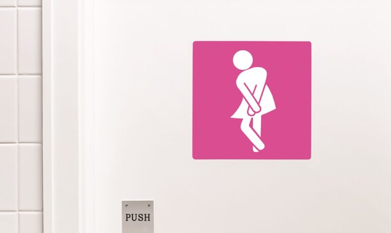 Female toilet sign, legs crossed urgent need to urinate