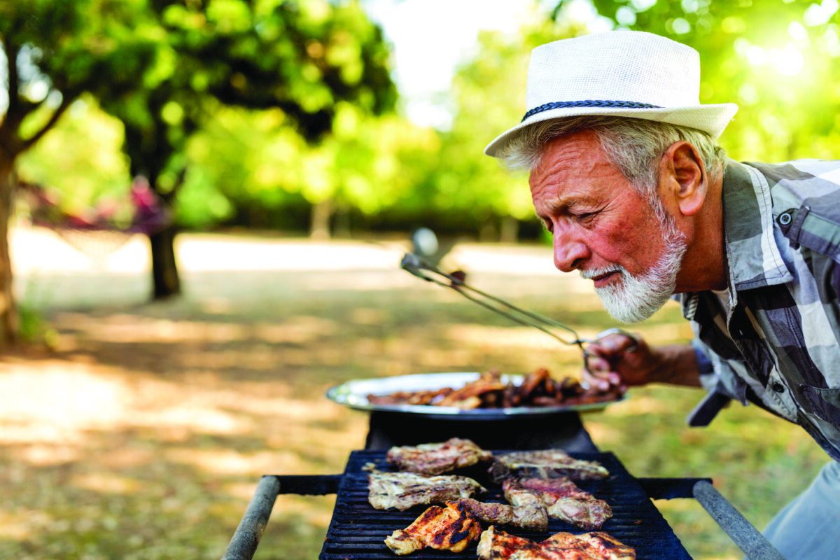 Barbecue outdoor in summer. Man cooking.