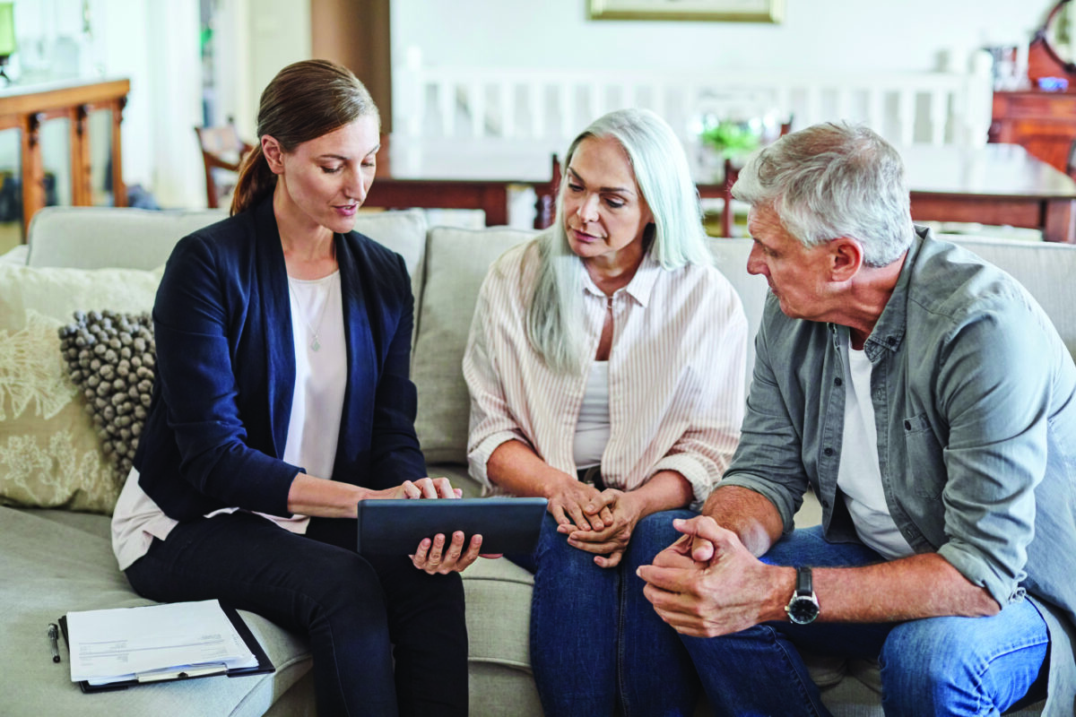 Female financial advisor explaining couple at home