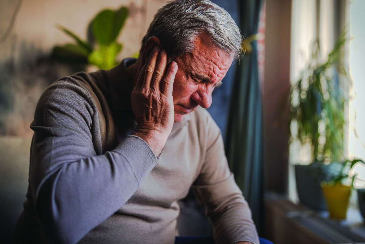 Stressed, unhappy man with severe earache