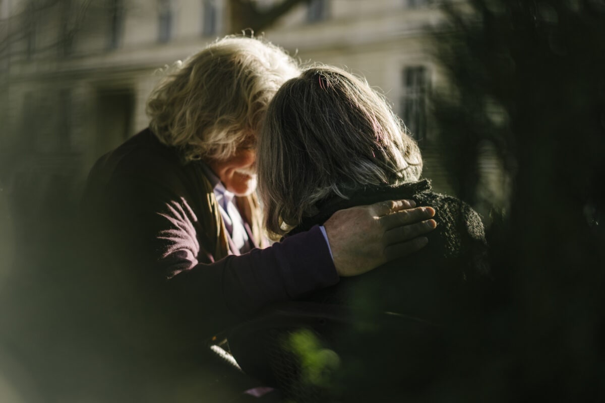 Rear view of senior couple with arm around each other