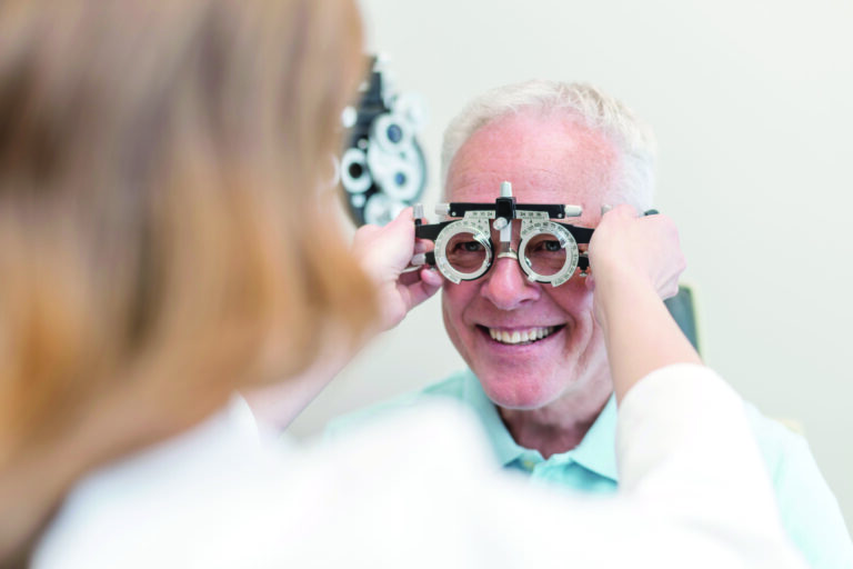 Optician testing mans eyesight