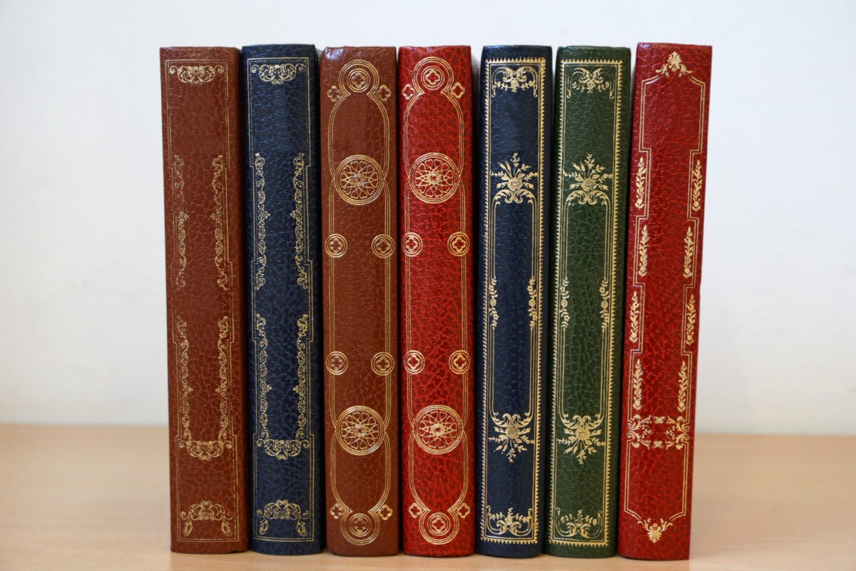 Various vintage cover books lined in the bookshelf