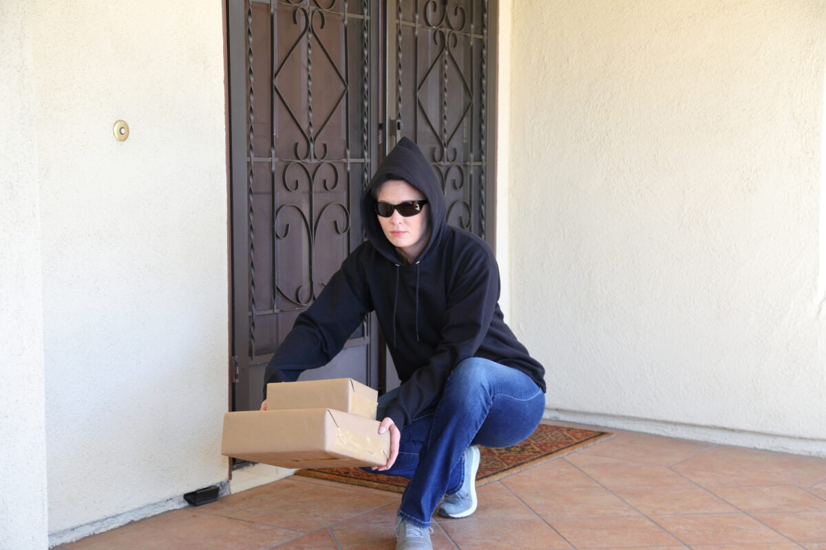 Porch Pirate Woman in Black Hoodie and Sun Glasses Horizontal