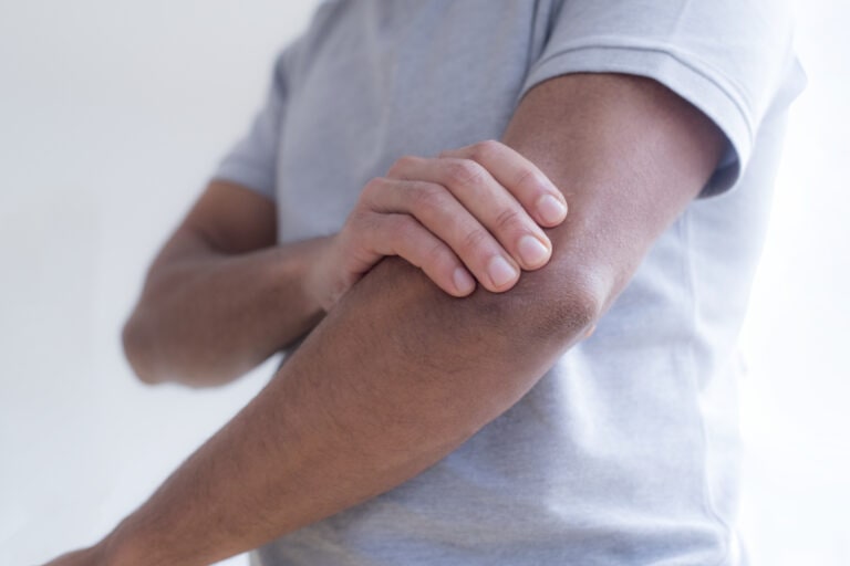 Man touching his elbow in pain