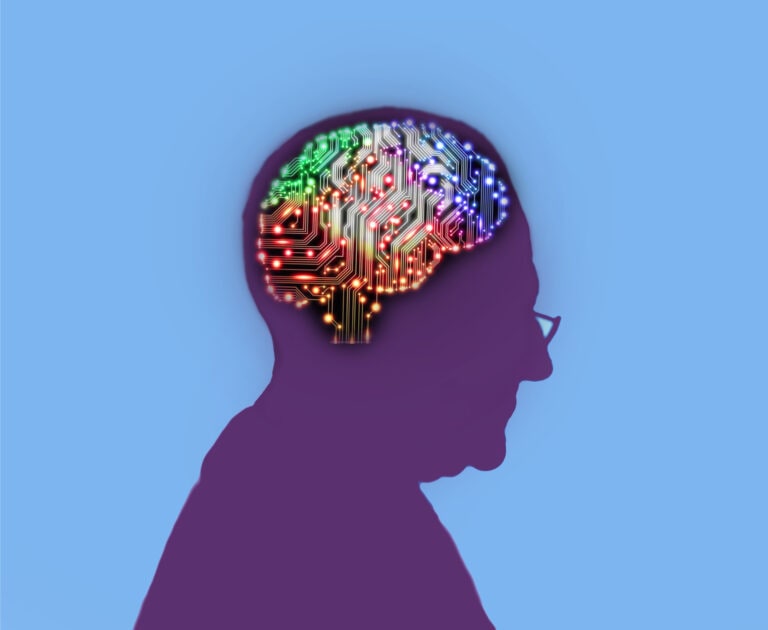 Profile of elderly man with an electric circuit brain lit up inside his head