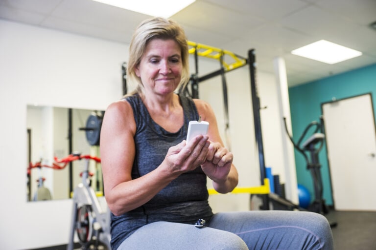 Diabetic patient testing her blood sugar in a gym