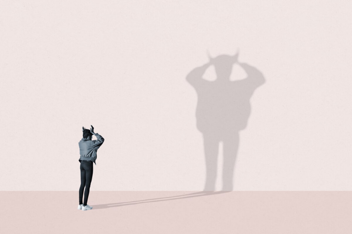 Young woman making devil shadow