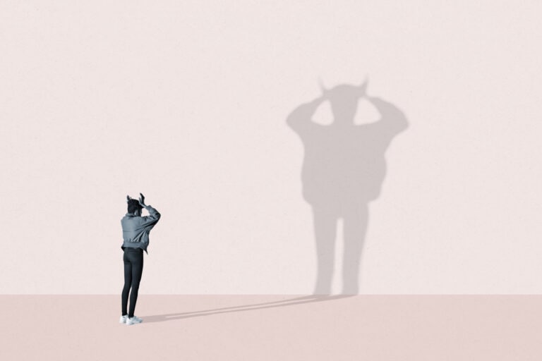Young woman making devil shadow