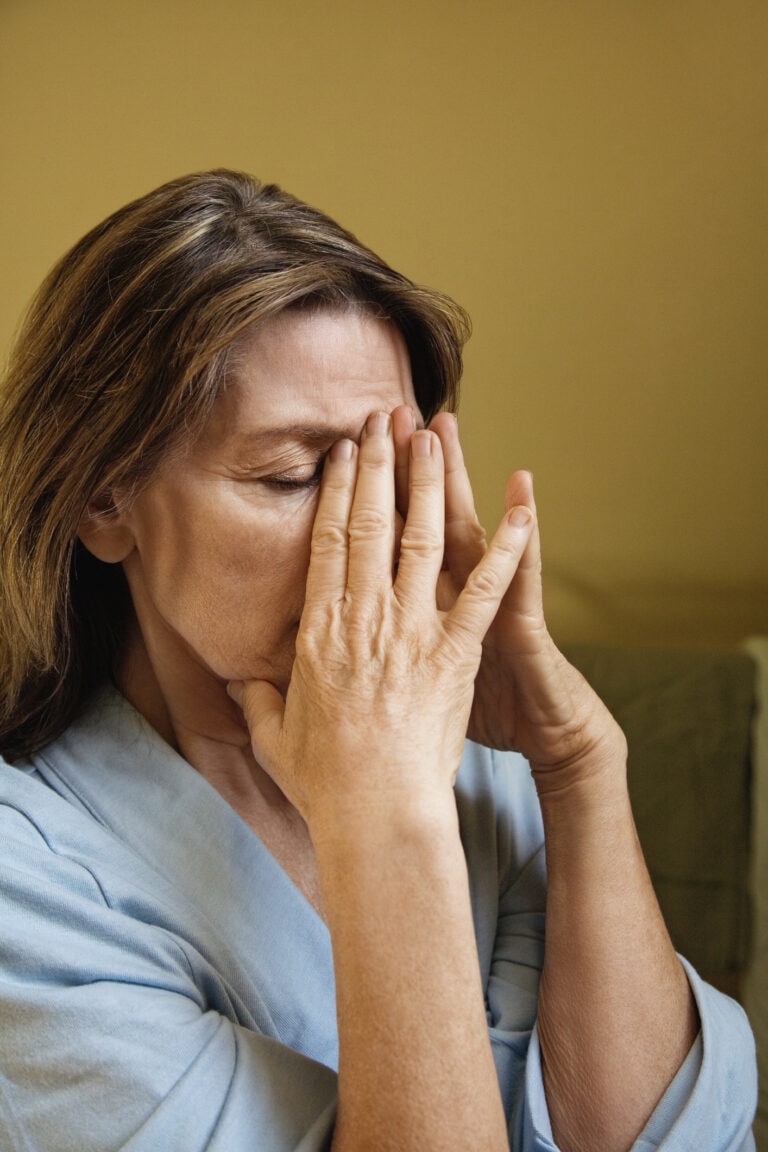 Woman rubbing eyes