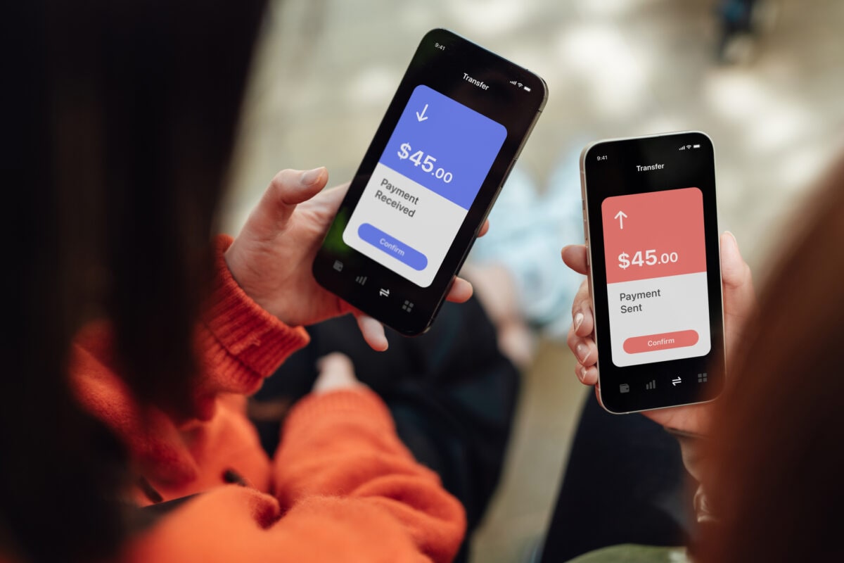 Two people sending and receiving money via mobile banking