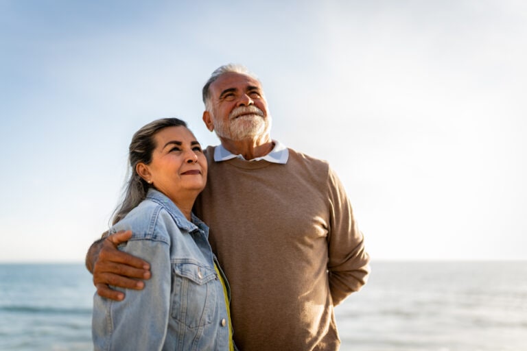 Senior couple looking away admiring the view on the beach