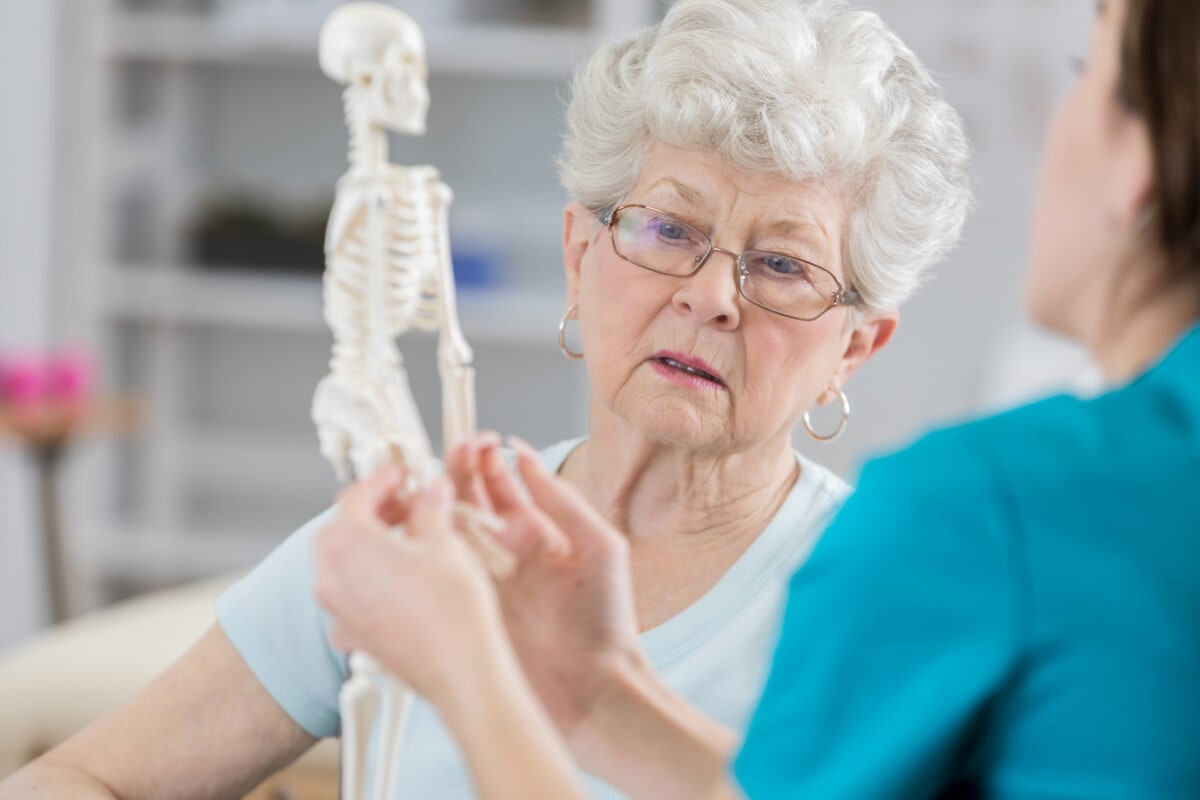 Senior woman discusses posture with physical therapist