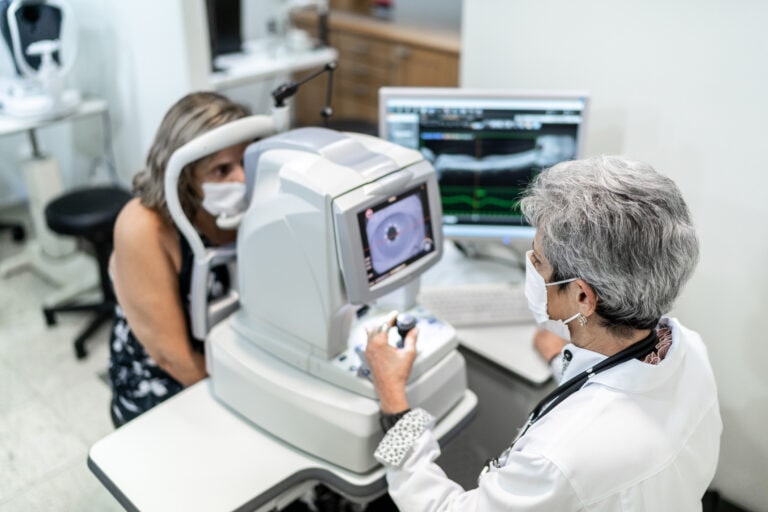 Optometrist examing patient's eyes