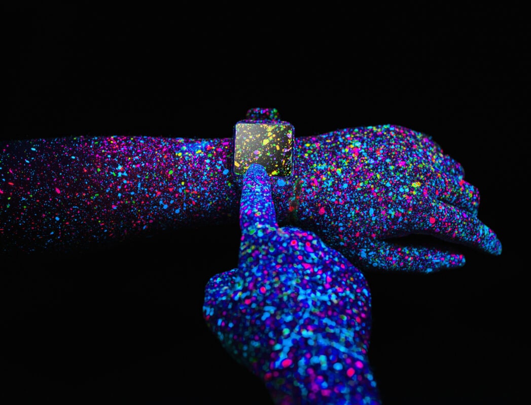 Man using a Smart Watch with black light