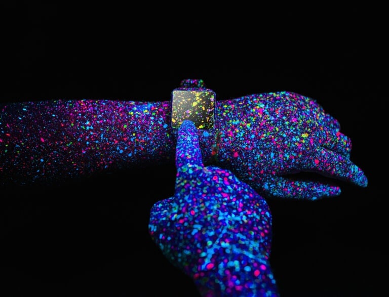 Man using a Smart Watch with black light