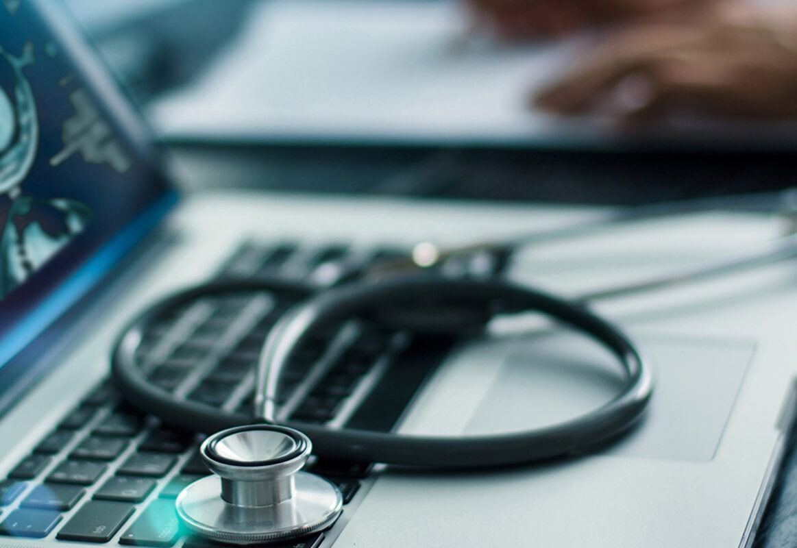 Stethoscope on top of laptop computer