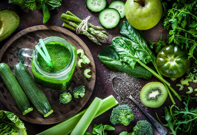 Green fruits and vegetables on a wood table