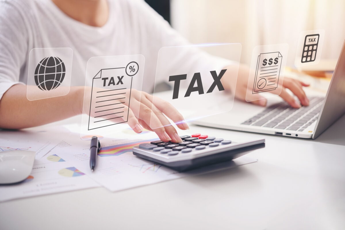 Hand of business woman accountant or banker making calculations. Tax, Savings, finances and economy audit debt with icon screen devices. Online Technology concept.