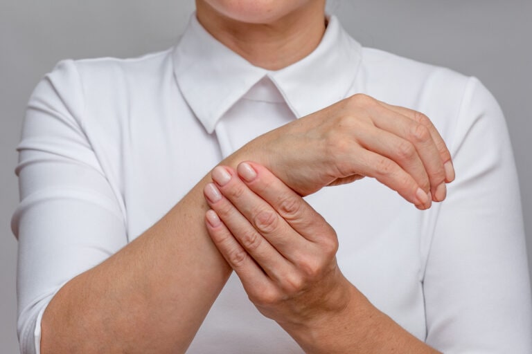 Woman hands showing right wrist pain