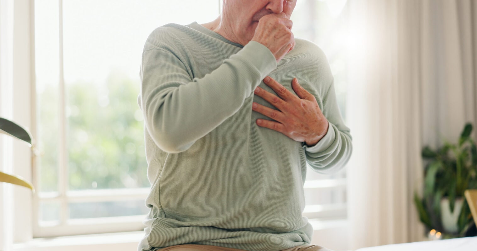 Coughing, sick and a person feeling chest for pain, heart attack or health problem at home. Healthcare, covid and a man with a cold, flu or virus of the lungs, infection or symptom of a disease