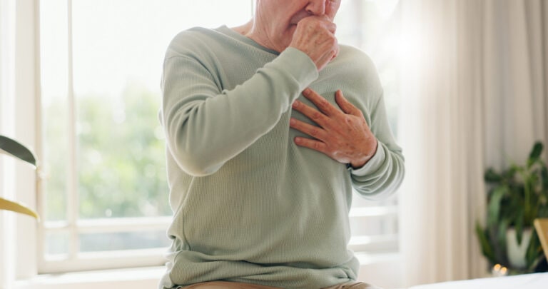 Coughing, sick and a person feeling chest for pain, heart attack or health problem at home. Healthcare, covid and a man with a cold, flu or virus of the lungs, infection or symptom of a disease