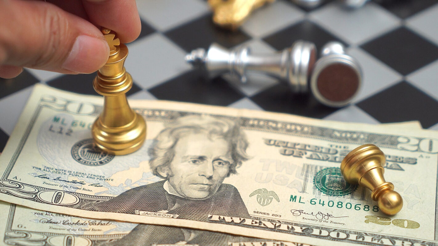 Chess Pieces on Dollar Bill, Symbolizing Financial Strategy