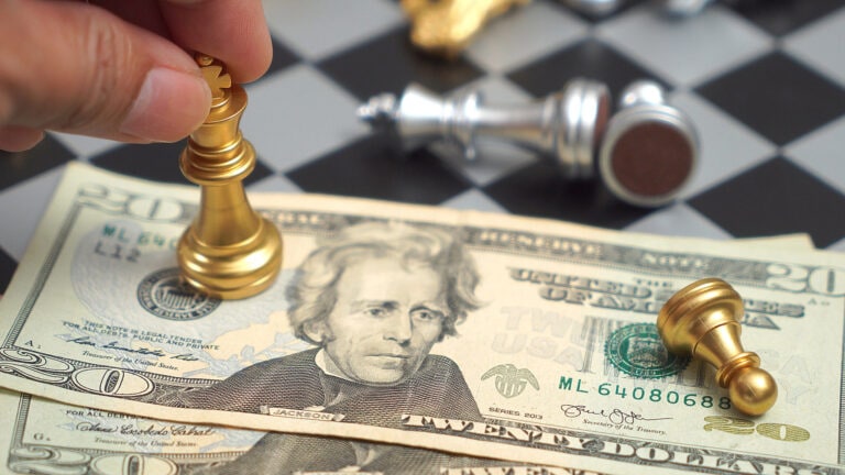 Chess Pieces on Dollar Bill, Symbolizing Financial Strategy