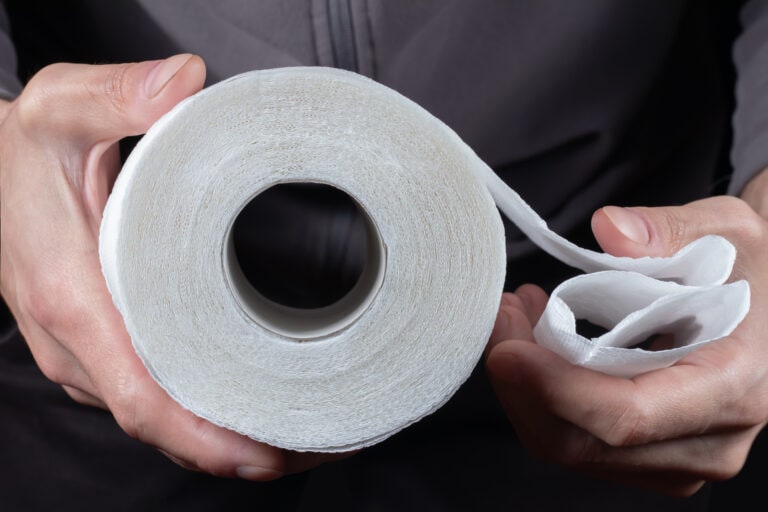 Close-up of in Hand using a toilet paper.